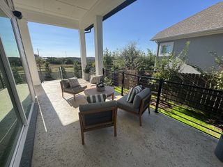 Model Home A spacious outdoor patio with cozy seating, modern railings, and scenic views, perfect for relaxing or entertaining.