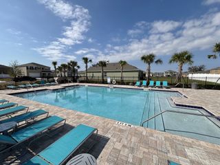 Community Amenities Resort-style pool retreat with palm trees, lounge chairs, and a sparkling blue pool in Oak Pointe by D.R. Horton (Apopka, FL).