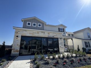 Street view Beautiful stone two-story home with manicured landscaping in Weston Oaks by View Homes (San Antonio, TX).