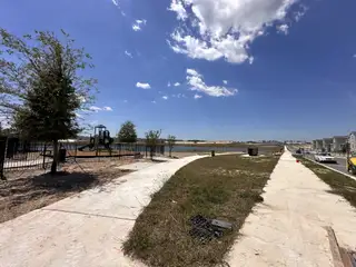 A scenic view with a park and playground in Bronson's Ridge by Lennar (Apopka, FL).
