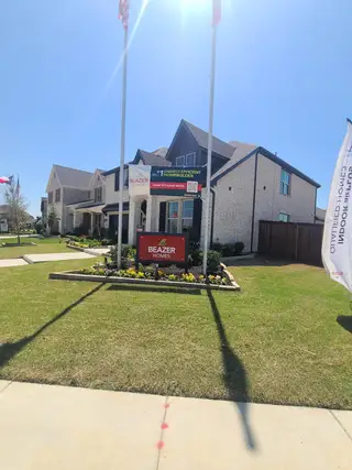 Street view A beautiful brick home with landscaped garden in Valencia on the Lake by Beazer Homes (Little Elm, TX).