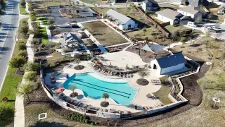 Community Amenities Aerial view of Homestead by Coventry Homes, featuring a pool, playground, and community space in Schertz, TX.