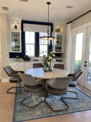 A chic dining space with a statement chandelier, built-in cabinetry, and elegant décor for intimate gatherings.