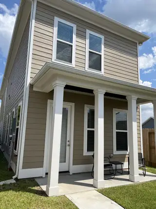 Charming two-story home with a cozy porch in Pearland Old Townsite by Sullivan Brothers Builders (Pearland, TX).