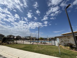 Community Amenities A vibrant community pool with a modern facility in Firefly Pointe: Cottage Collection by Lennar in Hutto, TX.