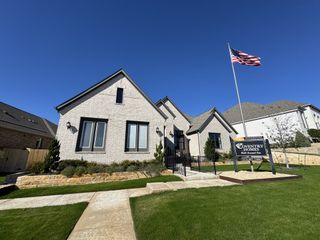Street view A stunning modern brick home with a well-manicured lawn in La Cima by Coventry Homes (San Marcos, TX)