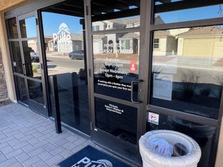 Pulte Homes office in McClellan Ranch features a glass entryway, offering a glimpse into the charming community in Laveen, AZ.