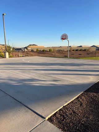A pristine community basketball court under clear skies in Copper Falls by D.R. Horton (Buckeye, AZ).