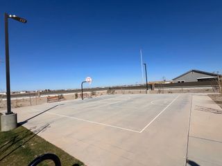 A spacious basketball court under clear skies in Rancho Mirage Signature Series by Meritage Homes (Maricopa, AZ).
