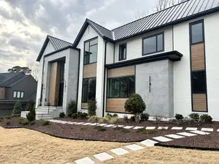 A modern home with sleek design and landscaped yard in North Hills by Homestead Building Company (Raleigh, NC).