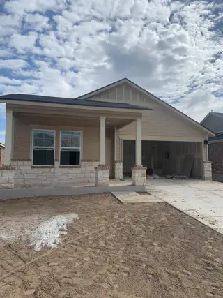 Street view A charming new home with a covered porch in Waterstone: Classic Collection by Lennar, Kyle, TX.