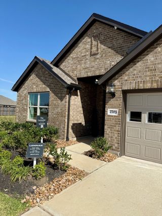 A charming brick home with modern finishes in Samara by Lennar (League City, TX), featuring a landscaped entryway and stylish curb appeal.