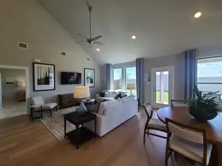 Spacious living area with high ceilings, modern furnishings, and large windows offering ample natural light.