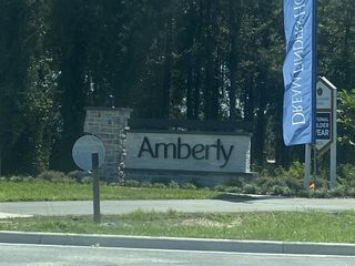 Street view Entrance to Amberly, a charming community by Dream Finders Homes, set amidst lush greenery in Green Cove Springs, FL.