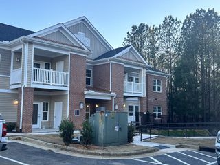 A modern brick and siding multi-family home in Weatherstone Creek by ExperienceOne Homes, LLC (Cary, NC).