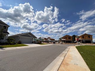 A busy street view showcasing model homes and Lennar’s sales center in Cascades by Lennar (Davenport, FL).