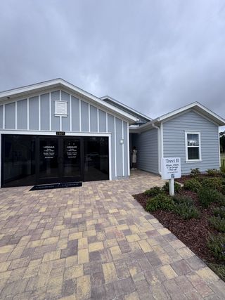Charming gray home with elegant entry and paver walkway in Seaton Creek: Seaton Creek 60s by Lennar (Jacksonville, FL).