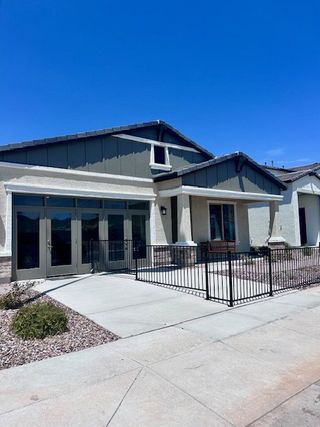 A modern home with sleek lines and a fenced yard in Laveen Vistas II by Homes by Towne (Phoenix, AZ).