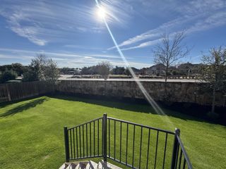 A serene and well-maintained backyard with a clear view of the large open space, ideal for family gatherings.