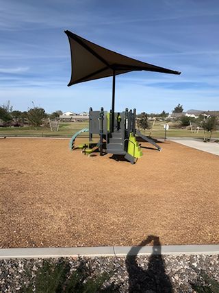 A vibrant playground under a shaded canopy in Edgewood Estates by K. Hovnanian® Homes (Queen Creek, AZ).