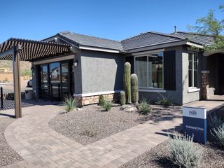 A modern home with desert landscaping in Aloravita by Pulte Homes, Peoria, AZ, featuring sleek design and natural elements.