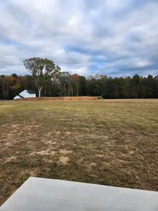 Street view Expansive open lot with serene natural views in Riverside by RiverWILD Homes (Zebulon, NC).