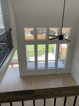 A stunning view from the second floor, looking down on the spacious living area with large windows.