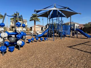 A vibrant playground with modern equipment in Ventana de Estrellas Enclaves by KB Home (Goodyear, AZ).