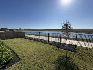 Street view A well-maintained backyard with a scenic water view in Waterstone: Stonehill Collection by Lennar (Kyle, TX).