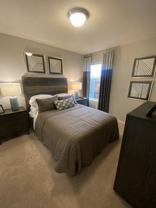 Cozy bedroom with modern decor, featuring a stylish bed, geometric wall art, and soft lighting for a relaxing ambiance.
