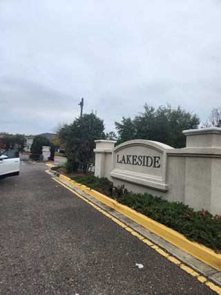 Street view Elegant entry with manicured landscaping at Lakeside Townhomes by Lennar (Jacksonville, FL).
