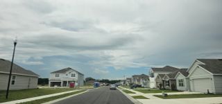 Street view Charming modern homes line this street in Avalon Woods by D.R. Horton, nestled in Newberry, FL.
