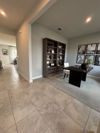 Model Home A modern, open-concept home with a spacious and elegant design. The home features a seamless flow between the kitchen, dining, and living areas, creating a bright and airy atmosphere.