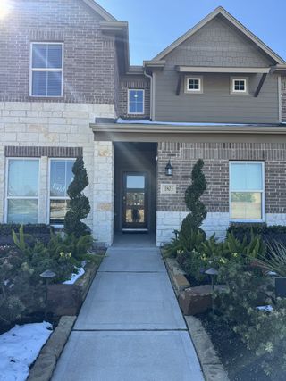 Charming brick home with elegant landscaping in Champions Oak by Long Lake Ltd. (Houston, TX).