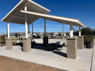 A modern pavilion with seating in McClellan Ranch - Reserve Series by Meritage Homes, Laveen, AZ, ideal for community gatherings.