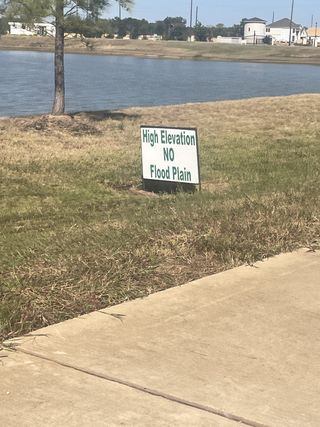 A scenic lakeside view at Tealpointe Lake Estates by Jamestown Estate Homes in Tomball, TX. High elevation, no floodplain concerns.