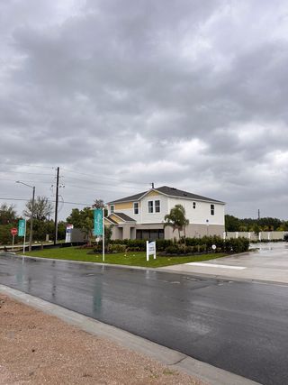 A modern two-story home with a landscaped yard in Bradbury Creek by Casa Fresca Homes, located in Haines City, FL.