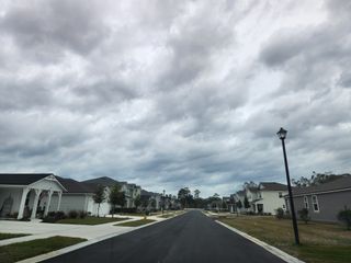 Street view Charming suburban street with modern homes in Olde Mandarin Estates by Mattamy Homes (Jacksonville, FL).