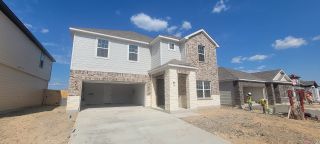 A modern two-story home with brick accents in Trails at Culebra by Ashton Woods, San Antonio, TX.