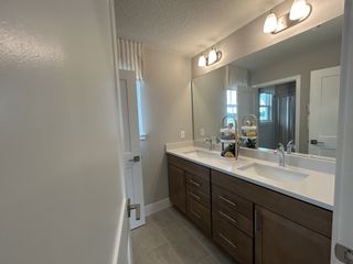 A chic bathroom featuring a dual-sink vanity, sleek fixtures, and soft lighting for a modern touch.