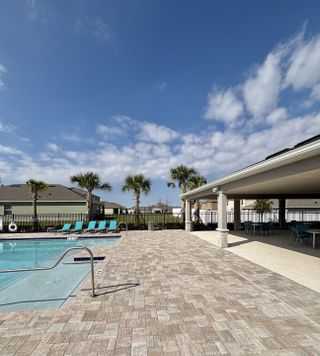 Community Amenities Resort-style pool retreat with palm trees, lounge chairs, and a sparkling blue pool in Oak Pointe by D.R. Horton (Apopka, FL).