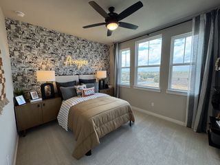 A comic-themed bedroom with bold wallpaper, cozy bedding, and large windows that bring in natural light.