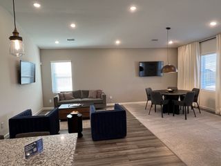 A cozy living room with modern furniture, a granite countertop, and natural light enhancing the inviting space.