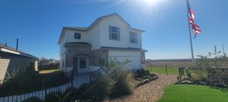 A beautiful corner lot home with lush landscaping and a manicured front yard in Avenida by D.R. Horton (Converse, TX).