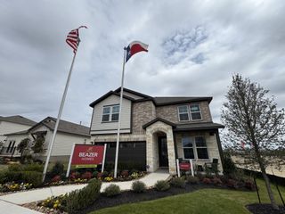 A beautiful brick home with lush landscaping in Hunter's Ranch by Beazer Homes, San Antonio, TX.