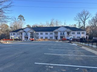 A developing multi-unit building with spacious parking in Weatherstone Creek by ExperienceOne Homes, LLC (Cary, NC).