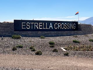 A welcoming entrance to Estates at Estrella Crossing by Ashton Woods, featuring a stone sign in Phoenix, AZ.