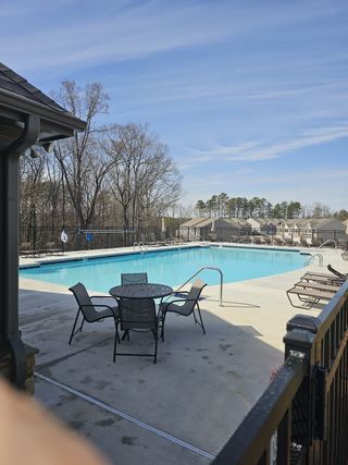 Community Amenities A sparkling community pool with lounge seating and scenic views, perfect for relaxation in Greyton Springs Place by D.R. Horton in (Buford, GA).