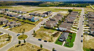 Aerial view of a growing community with new homes and green spaces in Cool Water by M/I Homes (Jarrell, TX).