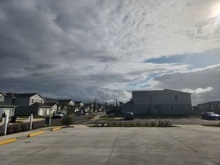 Street view Charming neighborhood under dramatic skies in Corsair by D.R. Horton, Middleburg, FL.